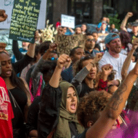 UC Davis student Kaleemah Muttaqi, 19, center with green scarf, joined the “Fists Up” chant during a Day of Action protest in downtown Sacramento hosted by Black Lives Matter Sacramento and the Anti Police-Terror Project in Sacramento, Calif., on Wed., April 4, 2018. They are seeking justice for Stephon Clark who was killed by Sacramento police in his grandmother’s backyard. RENEE C. BYER RBYER@SACBEE.COM Read more here: https://www.sacbee.com/opinion/op-ed/article248636275.html#storylink=cpy