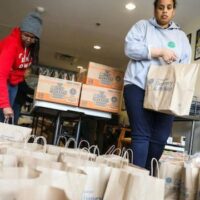 Volunteers packing food for people affected by the pandemic