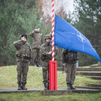 Raising of the NATO flag DRAWSKO POMORSKIE TRAINING AREA, Poland--The NATO flag is raised during the opening ceremony for Exercise Steadfast Jazz here Nov. 3. Exercise Steadfast Jazz 2013 is taking place from 1-9 November in a number of Alliance nations including the Baltic States and Poland. The purpose of the exercise is to train and test the NATO Response Force, a highly ready and technologically advanced multinational force made up of land, air, maritime and special forces components that the Alliance can deploy quickly wherever needed. The Steadfast series of exercises are part of NATO’s efforts to maintain connected and interoperable forces at a high-level of readiness. (NATO photo by British army Sgt. Ian Houlding)