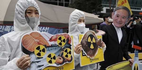 | Environmental activists wearing a mask of Japanese Prime Minister Yoshihide Suga and protective suits perform to denounce the Japanese governments decision on Fukushima water near the Japanese embassy in Seoul South Korea | MR Online