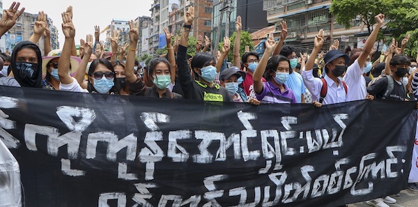 | Anti coup protesters flash the three finger salute holding banner read Yangon Strike will defeat all enemies during a demonstration against the military coup in Yangon Myanmar on Monday April 26 2021 | MR Online