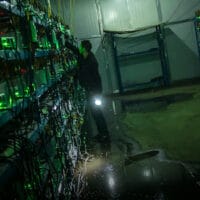 | A worker checks the equipment inside a bitcoin mine in rural Sichuan province 2016 Liu XingzhePeople Visual | MR Online