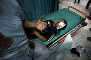 | A wounded boy lies on a stretcher following an Israeli attack in Beit Lahiya Gaza May 10 2021 Mohammed Ali | AP | MR Online