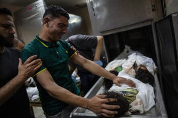 | A relative mourns over the bodies of four young brothers from the Tanani family killed in an Israeli airstrike in Gaza May 14 2021 Khalil Hamra | AP | MR Online