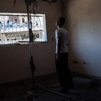 Mahmoud Ahmed, 34, gives a tour of his apartment, which was severely damaged by an Israeli airstrike on a neighboring building, May 24, 2021, in Magazzi, the Gaza Strip. John Minchillo | AP