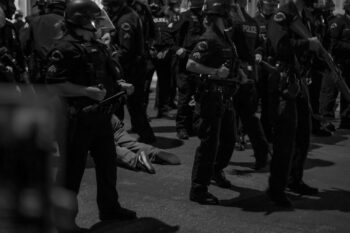 | A protester is arrested and dragged on asphalt by police officers Photo credit Jeremy Lindenfeld WhoWhatWhy | MR Online