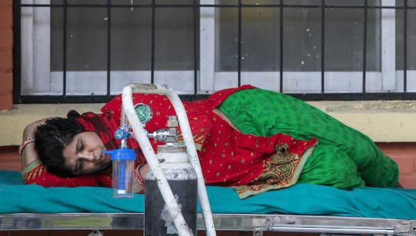 | A COVID 19 patient waits to receive oxygen outside an emergency ward of a hospital in Kathmandu Nepal | MR Online