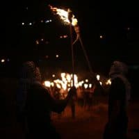 PALESTINIANS CARRY TORCHES DURING A NIGHT DEMONSTRATION AGAINST THE EXPANSION OF A JEWISH SETTLEMENT ON THE LANDS OF BEITA VILLAGE, NEAR THE OCCUPIED WEST BANK CITY OF NABLUS, ON JUNE 23, 2021. PHOTO BY SHADI JARAR’AH (C) APA IMAGES.