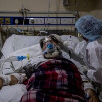 A medical worker tends to a patient suffering from the coronavirus disease (COVID-19), inside the ICU ward at a hospital in New Delhi, India, April 29, 2021