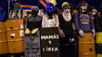 | A group of protesters from the first line stand behind their homemade shields during a Bogotá demonstration as Colombias national strike continues Among them the First Line Mothers a group of mothers who stand together against police violence credit Antonio Cascio | MR Online