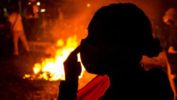 | Silhouette of a woman in front of a fire on the streets of Bogotá during Colombias national strike credit Antonio Cascio | MR Online