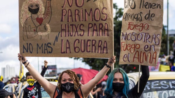 | In Bogotá during Colombias national strike two women hold placards that say We didnt give birth to children of war and They got firearms we got fire in our soul credit Antonio Cascio | MR Online