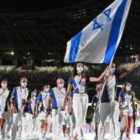 FLAG BEARERS HANNA MINENKO AND YAKOV TOUMARKIN OF TEAM ISRAEL DURING THE OPENING CEREMONY OF THE TOKYO 2020 OLYMPIC GAMES, JULY 23, 2021