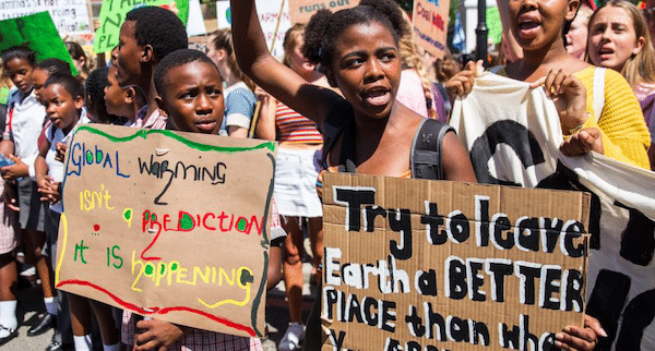 | 11th Grader Zenile Ngcame of Masiphumelele High School raises her fist during a 2019 protest for action against climate change outside Parliament in Cape Town | MR Online