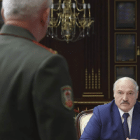 Belarusian President Alexander Lukashenko, right, pauses during a meeting with high level military officials in Minsk, Belarus, Aug. 5, 2021.