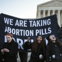Protesters gather in front of the U.S. Supreme Court as the justices hear arguments in Dobbs v. Jackson Women's Health, a case about a Mississippi law that bans most abortions after 15 weeks, on December 1, 2021, in Washington, D.C.