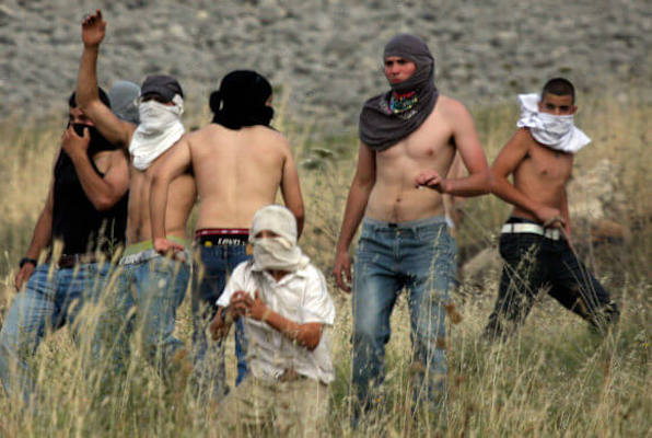 | ISRAELI SETTLERS FROM THE JEWISH SETTLEMENT OF YITZHAR THROW STONES DURING CLASHES WITH PALESTINIANS FROM THE VILLAGE OF ASIRA AL QIBILIYA SOUTH OF THE NORTHERN WEST BANK CITY OF NABLUS ON MAY 19 2012 PHOTO WAGDI ESHTAYAHAPA IMAGES | MR Online