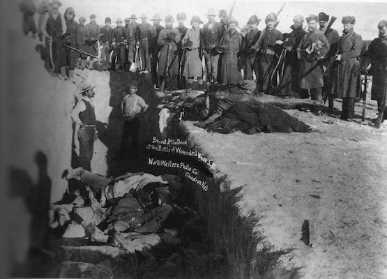 | Burial of the dead after the massacre of Wounded Knee in South Dakota US Soldiers are shown putting Indians in a common grave some corpses are frozen in different positions Source wikipediaorg | MR Online