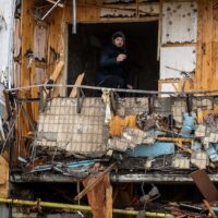 photo | A man inspects the damage at a building in Kiev, Ukraine, Feb. 25, 2022. Emilio Morenatti | AP