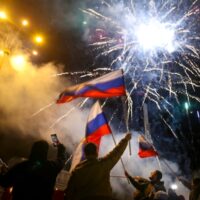 People wave Russian national flags celebrating Moscow’s recognition Donetsk and Lugansk, eastern Ukraine, Feb 21, 2022