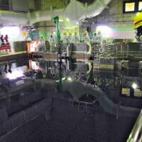image shows 2013 IAEA team member overseeing TEPCO moving nuclear fuel assemblies from Reactor Unit 4 to the Common Spent Fuel Pool. (Photo: IAEA)