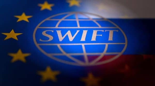 | Swift logo is pictured with EU and Russian flags in this illustration picture taken February 26 2022 | MR Online