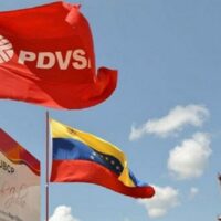 | PDVSA flag next to Venezuelan flag near a PDVSA facility File photo | MR Online