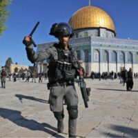 | A member of the Israeli security forces attacks worshippers at the Dome of the Rock mosque during clashes at Jerusalems al Aqsa Mosque compound on 15 April 2022 AFP | MR Online