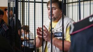 | Ruslan Kotsaba Ukrainian journalist and conscientious objector in a cage during a recent court trial credit friendspeaceteamsorg | MR Online