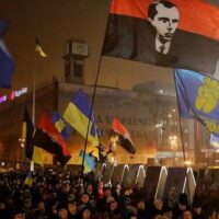 2015 march in Kiev to celebrate the birthday of Nazi collaborator Stepan Bandera (pictured on black and red flag)