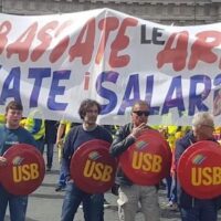 USB union with banner reading: "Lower your weapons, raise your wages."