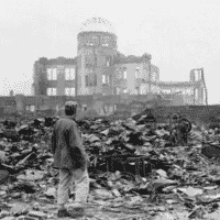 Man stands amid ruins of Hiroshima. [Source: time.com]