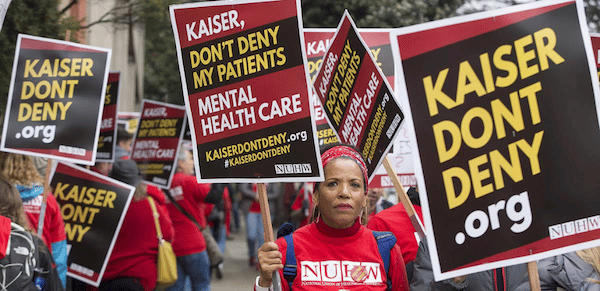 | After whistleblowing short strikes and a year of contract negotiations Kaiser mental health workers are on their first ever open ended strike They say patients shouldnt have to wait months for a therapy appointment Photo NUHW | MR Online