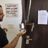 DEFENSE FOR CHILDREN INTERNATIONAL – PALESTINE’S OFFICE DOOR OUTSIDE RAMALLAH AFTER ISRAELI FORCES CONDUCTED A RAID AND DECLARED THE ORGANIZATION CLOSED ON AUGUST 18, 2022. (PHOTO CREDIT: AFP / ABBAS MOMANI VIA DCIP)