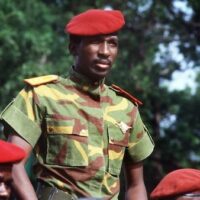 This file photograph shows Thomas Sankara as he reviews troops in a street of Ouagadougou, during celebrations of the second anniversary of the Burkina Faso’s revolution. Photo by Daniel Lane/AP.