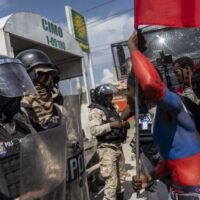 | A protester taunts police officers during Jean Jacques Dessalines Day in Port au Prince Haiti October 17 2022 courtesy AFP | MR Online