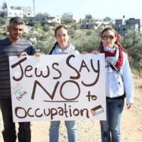 | Jewish activists holding an anti Israeli occupation banner Photo via Palestinian Christians Facebook Page | MR Online