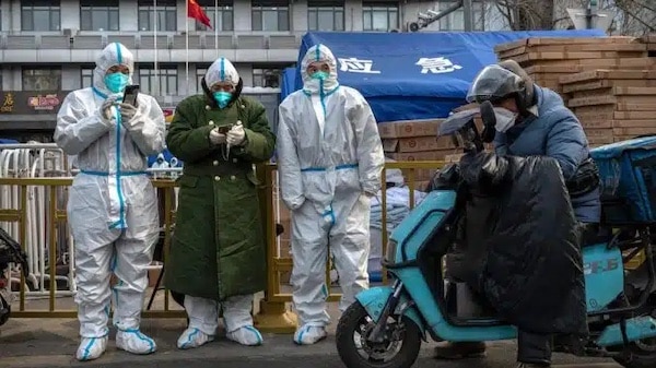 | Epidemic control workers wear PPE to prevent the spread of COVID 19 as they stand next to equipment for cold weather in an area where some communities are under lockdown on Nov 29 2022 in Beijing China | MR Online