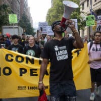 Chris Smalls, a leader of the Amazon Labor Union, leads a march of Starbucks and Amazon workers and their allies to the homes of their CEOs to protest union busting on Labor Day, September 5, 2022, in New York City, New York. ANDREW LICHTENSTEIN / CORBIS VIA GETTY IMAGES / Truthout