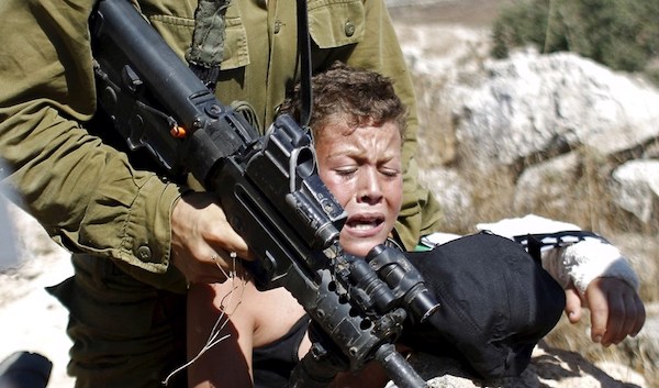 | IOF soldier restraining Palestinian boy in Ramallah Palestine August 28 2015 Photo Reuters | MR Online