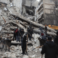 Rescuers carry a victim on the rubble as the search for survivors continues in the aftermath of an earthquake, in rebel-held town of Jindires, Syria, February 7, 2023. [Source: usnews.com]