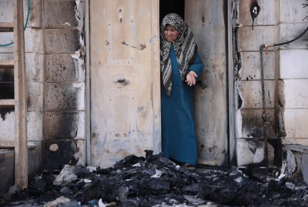| A Palestinian woman examines damage caused by the Jewish settler pogrom in the town of Huwwara in the occupied West Bank Photo Oren Ziv via ActiveStillscom | MR Online