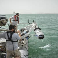 Members of an unmanned underwater vehicle detachment with U.S. Navy Commander Task Group (CTG) 56.1 guide a UUV as it is lowered into the water during a training exercise June 11, 2013, in Bahrain. (Source: MC1 Peter Lewis, Wikimedia commons)
