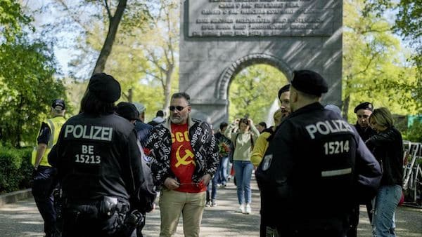 | Police officers ask a man wearing a shirt showing hammer and sickle to close his jacket outside the tomb of the Soviet War memorial at the park in Treptow during the 78th anniversary of Victory Day and the end of WWII in Europe in Berlin Germany Tuesday May 9 2023 AP PhotoMarkus Schreiber | MR Online