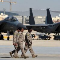 Saudi army officers walk past U.S.-made F-15 fighter jets displayed at King Salman air base in Riyadh. Jan. 25, 2017 (AP)