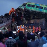 Rescuers attempt to remove body of a victim from passenger train that derailed in Balasore district, in the eastern Indian state of Orissa, Saturday, June 3, 2023. [AP Photo/Rafiq Maqbool]