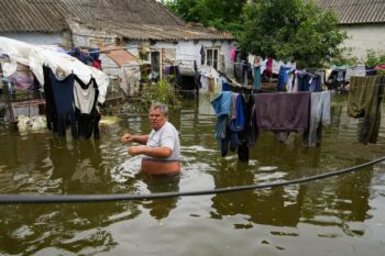 | A man in the flooded yard of his house in Afanasiyivka Mykolayiv region on 10 June 2023 following the destruction of the Kakhovka dam AFP | MR Online