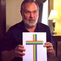 American Pastor Scott Lively showing his book