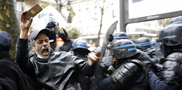 | Riot police officers charge a man holding his phone during a protest rally in Paris France Saturday Dec12 2020 | MR Online