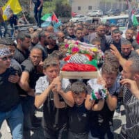 PALESTINIAN CHILDREN CARRY THE BODY OF 3-YEAR-OLD MOHAMMED AL-TAMIMI, WHO WAS SHOT DEAD BY ISRAELI FORCES IN THE WEST BANK VILLAGE OF NABI SALEH, JUNE 6, 2023. (PHOTO: AHMAD AROURI/APA IMAGES)